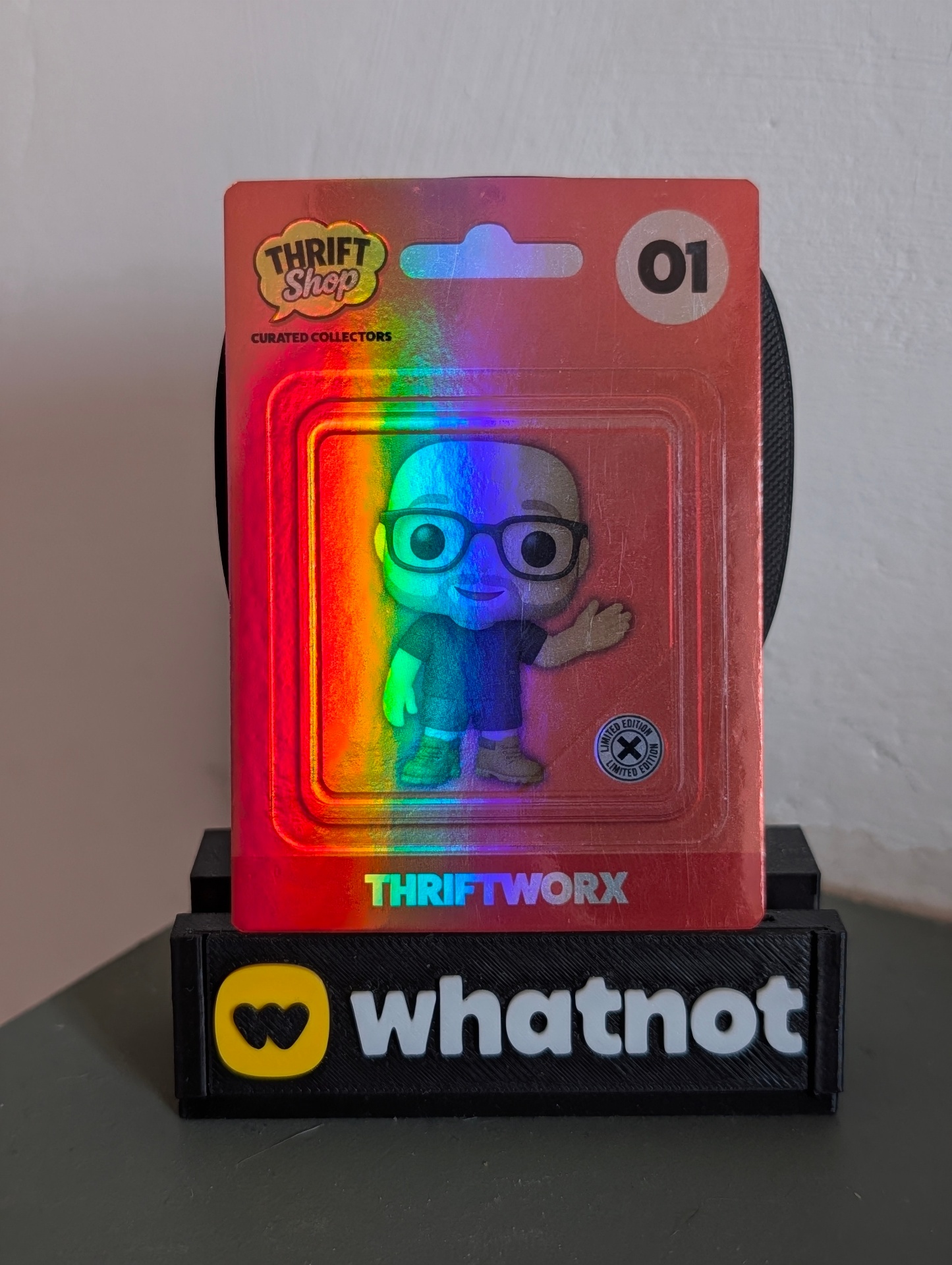 Card №01 — @THRIFTWORX front with holographic blister-pack framing.