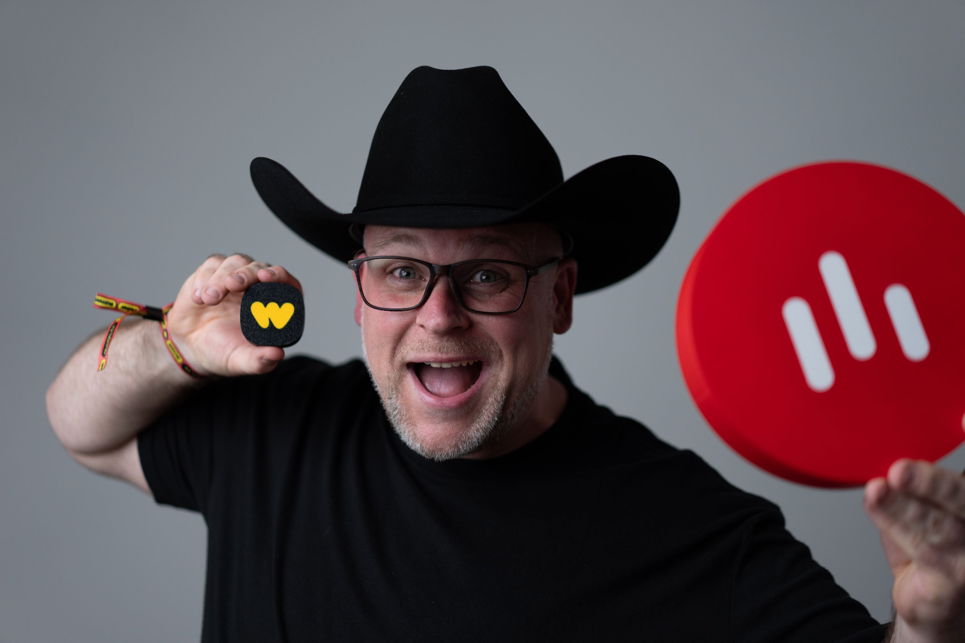 Darren Millar in a black cowboy hat holding a Whatnot microphone cover and the Whatnot logo.